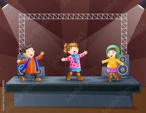 Happy kids singing on the stage