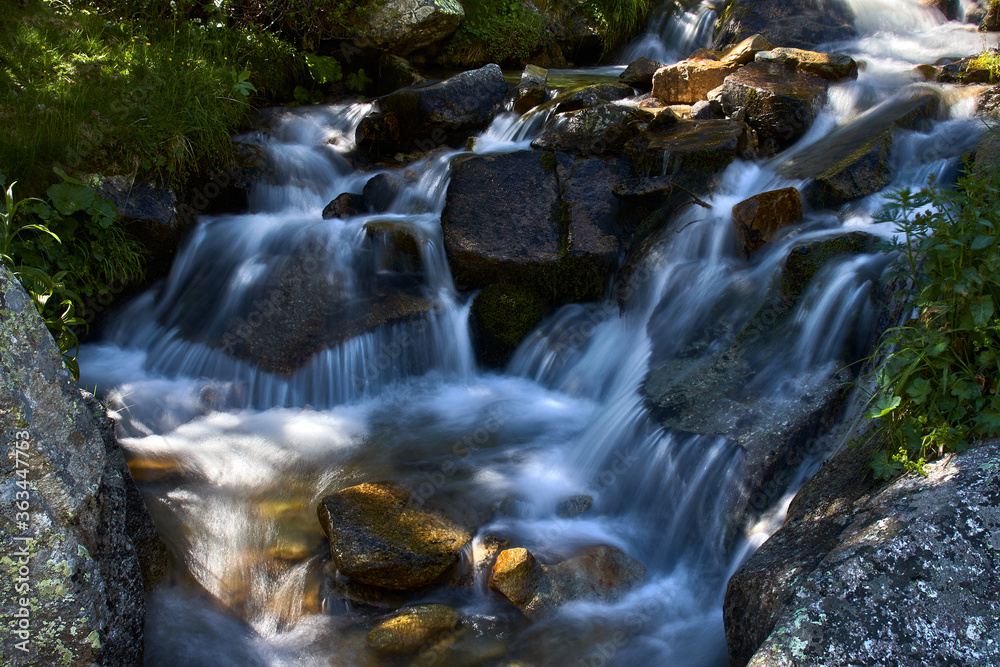 Waterfalls among the rocks of a small river