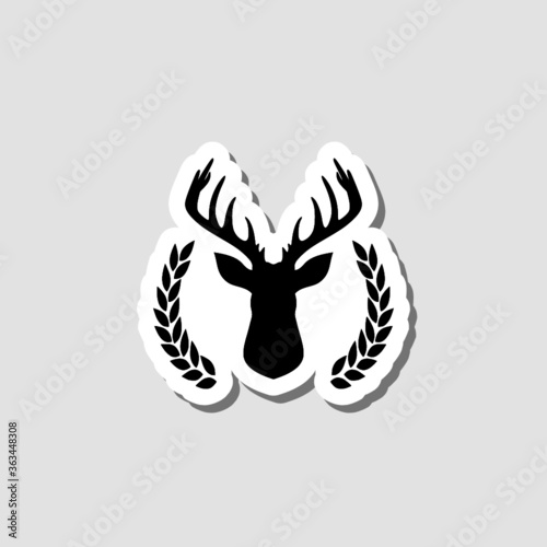Hunting trophy. Deer head with big antlers in laurel wreath sticker isolated on gray background