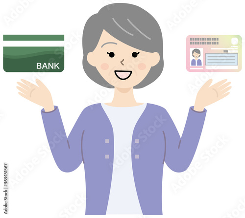 マイナンバーカードと銀行通帳を持つ高齢女性