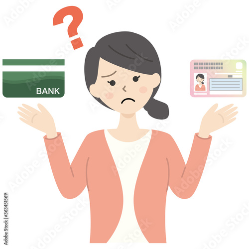 マイナンバーカードと銀行通帳を持つ疑問の女性