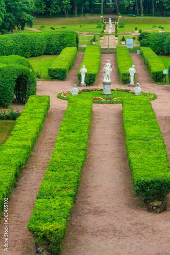 Marble statue of the goddess Flora surrounded by marble bacchantes and satyrs in Private Garden of Gatchina palace, Russia. View from above photo