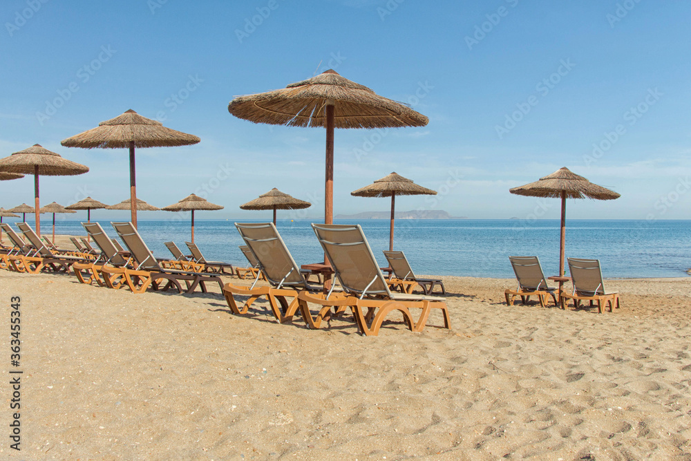 Parasols and sun loungers on the beach