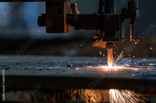CNC Plasma cutting. It is a process that cuts through electrically conductive materials by means of an accelerated jet of hot plasma. photo