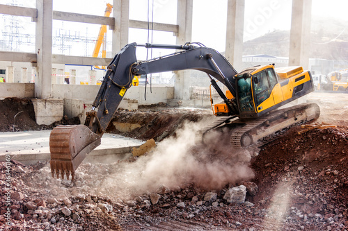 The excavator is digging and excavation in the new construction site. After the Industrial Revolution, mechanization via steam shovels and later hydraulic equipment.