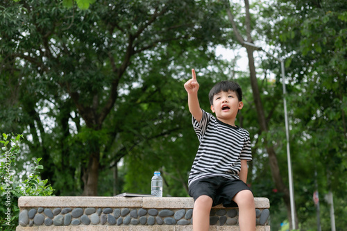 Portrait of a happy little boy in the park