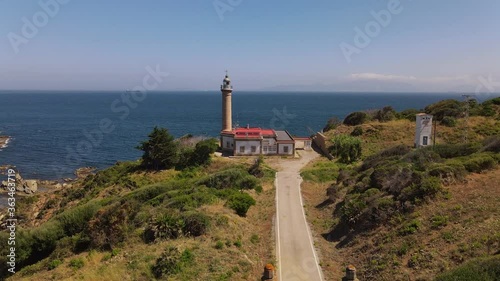 This Carnero lighthouse is in the south of Spain. It is a sunny July day. In the background, the Strait of Gibraltar and the African coast can be seen in the haze.