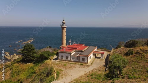 Aerial view on the Strait of Gibraltar. This Carnero lighthouse is in the south of Spain. The African coast in the haze and many ships can be seen in the background.