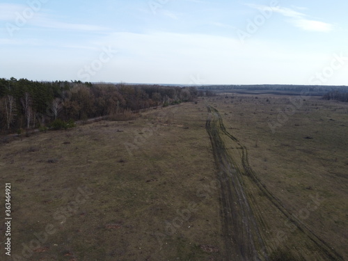 Huge lifeless wasteland  top view. Edge of a leafless spring forest. Landscape.