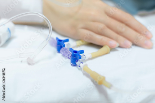 Fototapeta Naklejka Na Ścianę i Meble -  Close up of a woman patient in hospital with saline intravenous