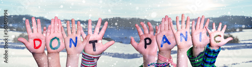 Kids Hands Holding Colorful English Word Do Not Panic. Snowy Winter Background With Snowflakes