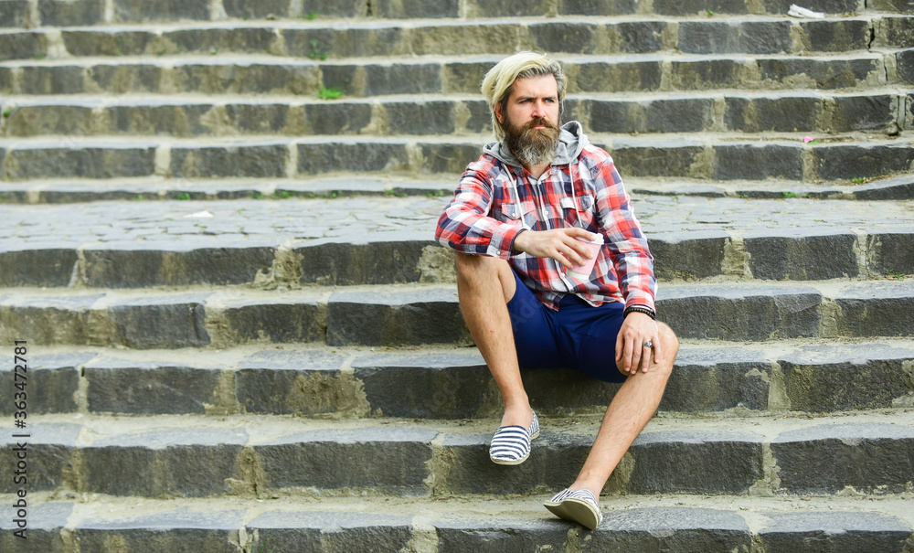 Hipster relax on stairs. Having rest. Caffeine dose. Pure pleasure. Good mood. Bearded man drink coffee urban background. Take away coffee. Third wave coffee culture. Man with beard drinking coffee Hipster relax on stairs. Having rest. Caffeine dose. Pure pleasure. Good mood. Bearded man drink coffee urban background. Take away coffee. Third wave coffee culture. Man with beard drinking coffee