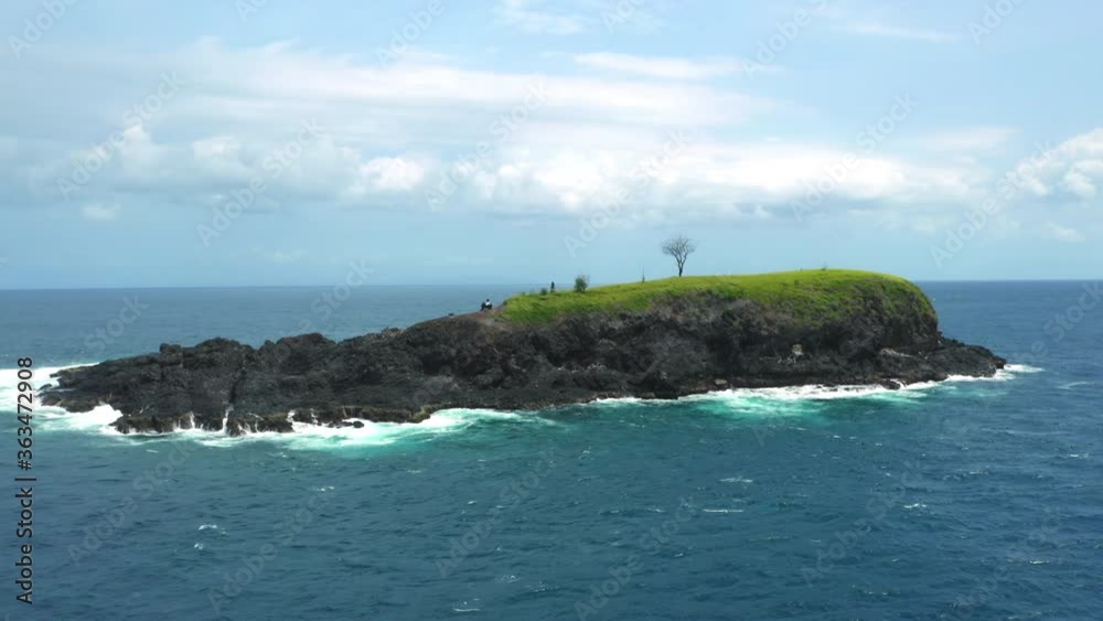 Aerial Tracking Shot Of A Beautiful Island Isolated In Blue Ocean Landscape Aerial Tracking Shot Of A Beautiful Island Isolated In Blue Ocean Landscape