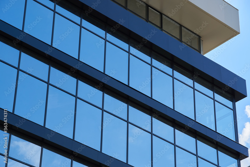 facade of a modern building on a bright Sunny day, blue sky and clouds reflecting in a glass, beautiful exterior of the new building facade of a modern building on a bright Sunny day, blue sky and clouds reflecting in a glass, beautiful exterior of the new building