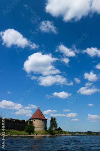 Summer view to Shlisselburg  Oreshek  fortress on the island of Ladoga lake under beautiful bright blue sky with clouds