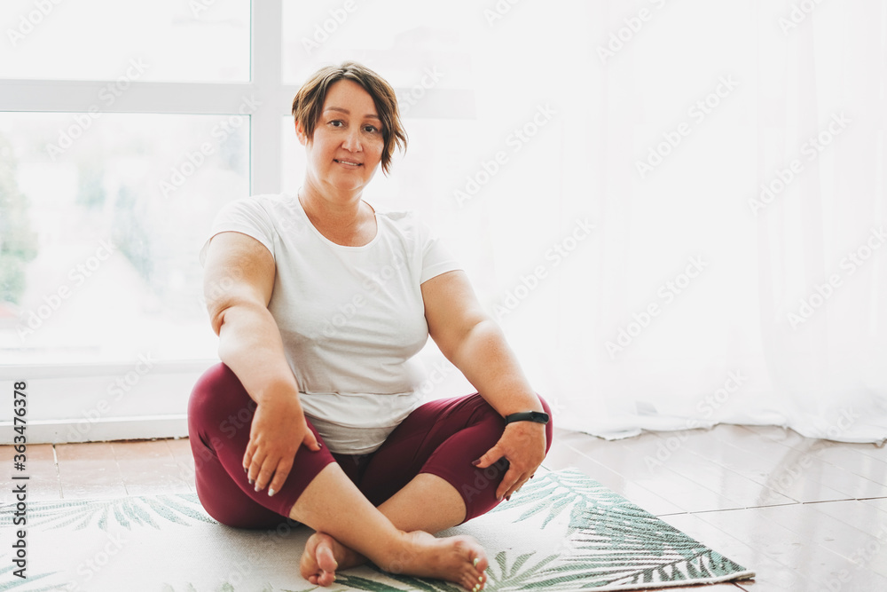 Φωτογραφία Adult charming brunette woman plus size body positive practice yoga at the brigh