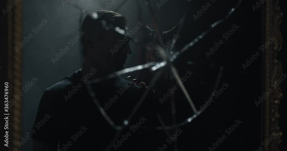 Reflection in the broken mirror of a man walking away from a demon woman, 4k