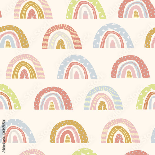 Vector seamless pattern of cute cartoon rainbows on an isolated white background. Hand drawn rainbow. Illustration of children on a greeting card, a print on fabric, clothes and wrapping paper. Flat 
