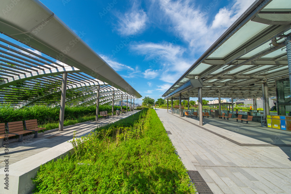 A rest stop in a park in the heart of a modern city.