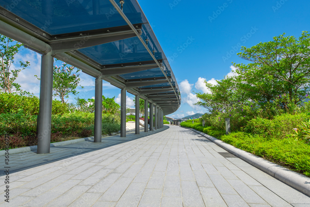Glass shade corridors in modern parks under the blue sky and white clouds. Glass shade corridors in modern parks under the blue sky and white clouds.