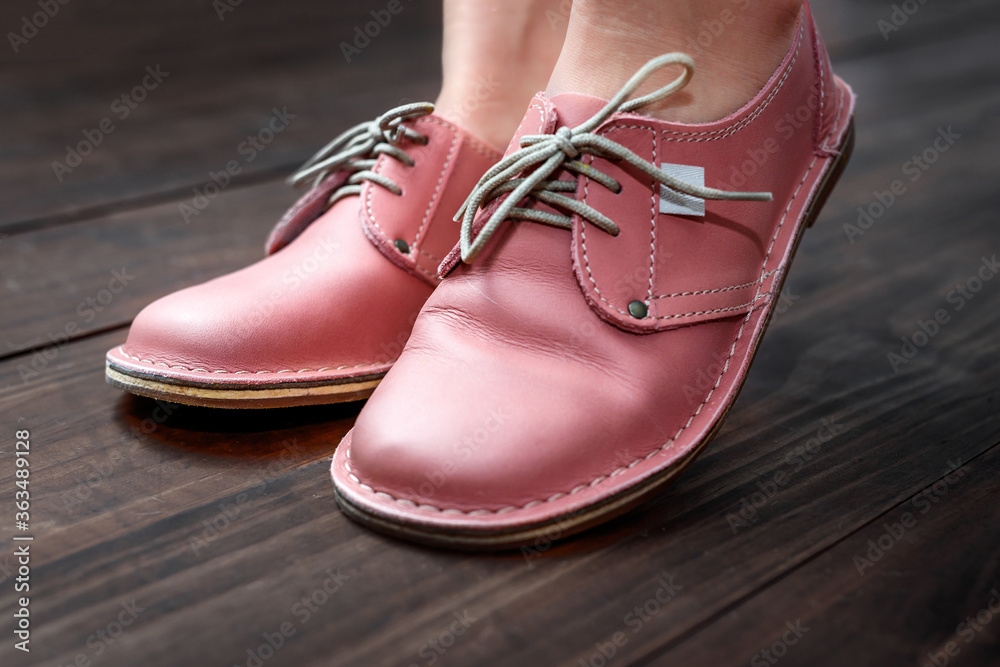 Pink ladies leather shoes isolated close-up