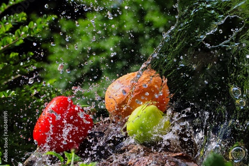 Pouring Water on Green Apple, Grapefruit and Red Pepper on Stone in Czech Republic. Freeze Motion of Fruits and Vegetable in Water Splash in the Garden. 