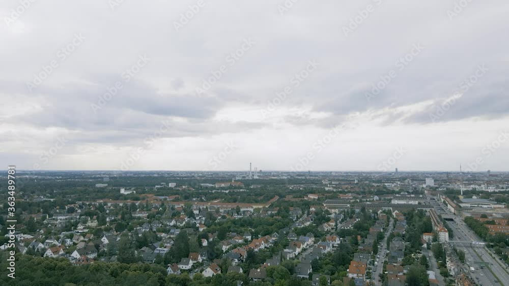 Aerial view of suburbs in Munich, capital of Bavaria in Germany. Residential buildings are situated next to green forest and recreation areas Aerial view of suburbs in Munich, capital of Bavaria in Germany. Residential buildings are situated next to green forest and recreation areas