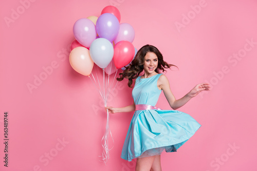 Photo of positive cheerful girl hold many air balloons enjoy anniversary party celebration wear good look clothes isolated over pastel color background