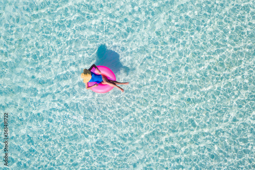 Top above high angle aerial drone view of her she attractive girl floating on rubber ring in sea water enjoy joy dream luxury tour sunny weather leisure activity romantic weekend © deagreez
