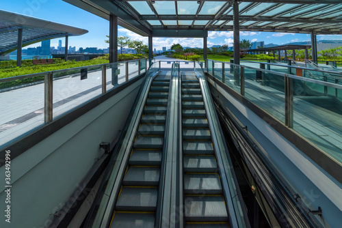 Modern glass elevator and pedestrian stairway entrances. © 一飞 黄