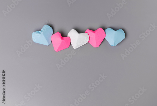 Origami paper hearts in transgender flag colors