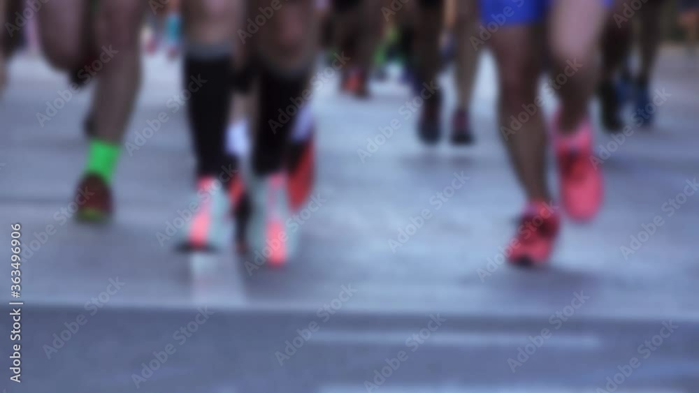 Blurred runners running the marathon in the city Blurred runners running the marathon in the city