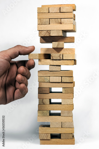 wooden tower bricks game a critical piece is about to be pulled