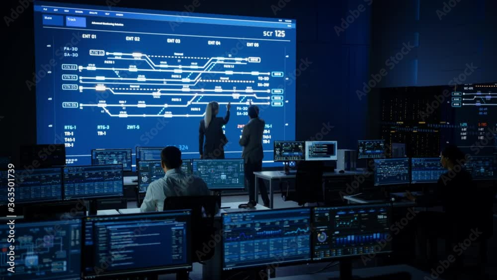 Project Manager And Computer Science Engineer Talking While Using Big project-manager-and-computer-science-engineer-talking-while-using-big