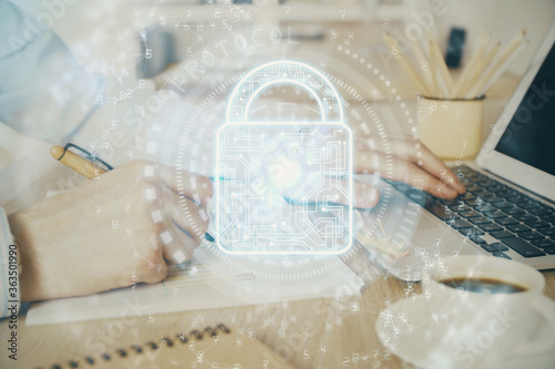 Double exposure of lock icon with man working on computer on background. Concept of network security. © peshkova