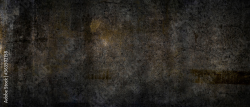Texture of a grungy black cement wall as background