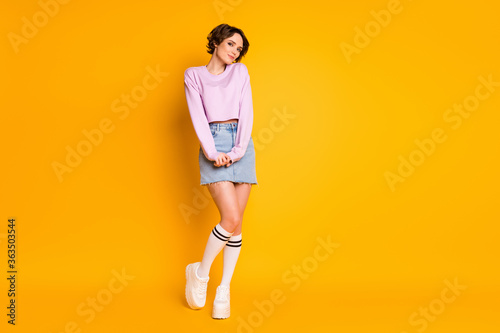 Full length body size view of her she nice-looking attractive lovely charming shy slender cheery girl wearing teen look posing isolated on bright vivid shine vibrant yellow color background