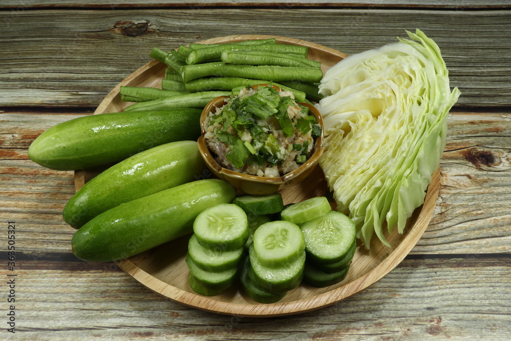 Traditional fish meat paste seasoning with chilly, shallot, garlic, lime and parsley serving with fresh cucumber, green bean and cabbage. Famous spicy seafood paste in Asia. Low fat and diet menu. Traditional fish meat paste seasoning with chilly, shallot, garlic, lime and parsley serving with fresh cucumber, green bean and cabbage. Famous spicy seafood paste in Asia. Low fat and diet menu.