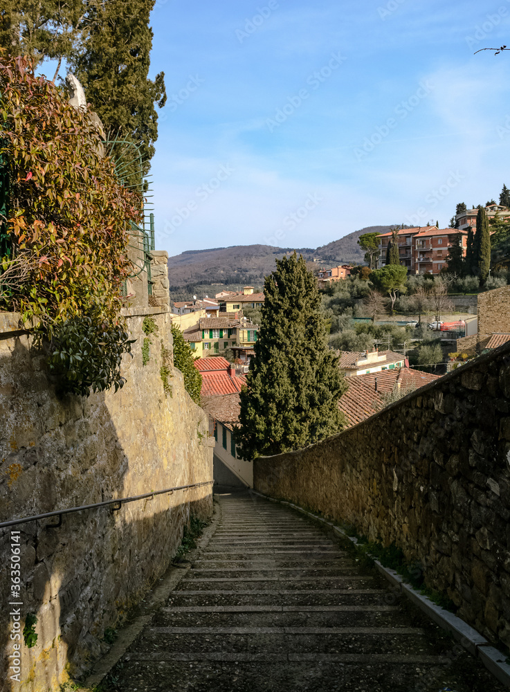 A stairway in the path of a city tour in Fiesole a small village with nice landscape view on the hills closed to Florence in Tuscany, Italy