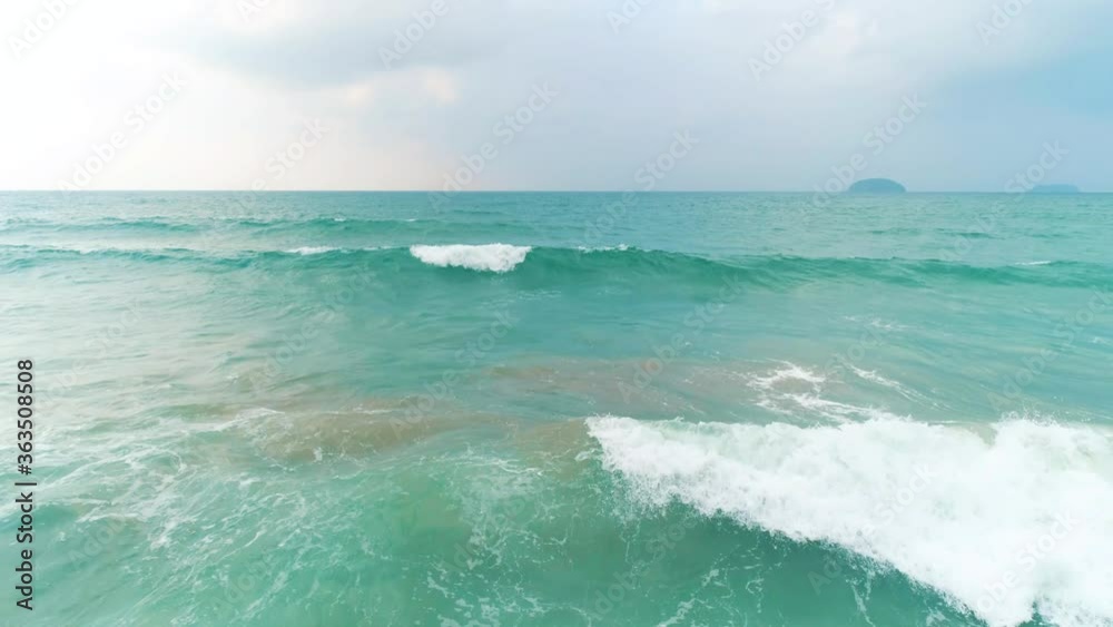 Aerial view of blue ocean with beautiful foaming rolling waves at cloudy day. Travel concept. Nacpan beach, Palawan, Philippines. Aerial view of blue ocean with beautiful foaming rolling waves at cloudy day. Travel concept. Nacpan beach, Palawan, Philippines.