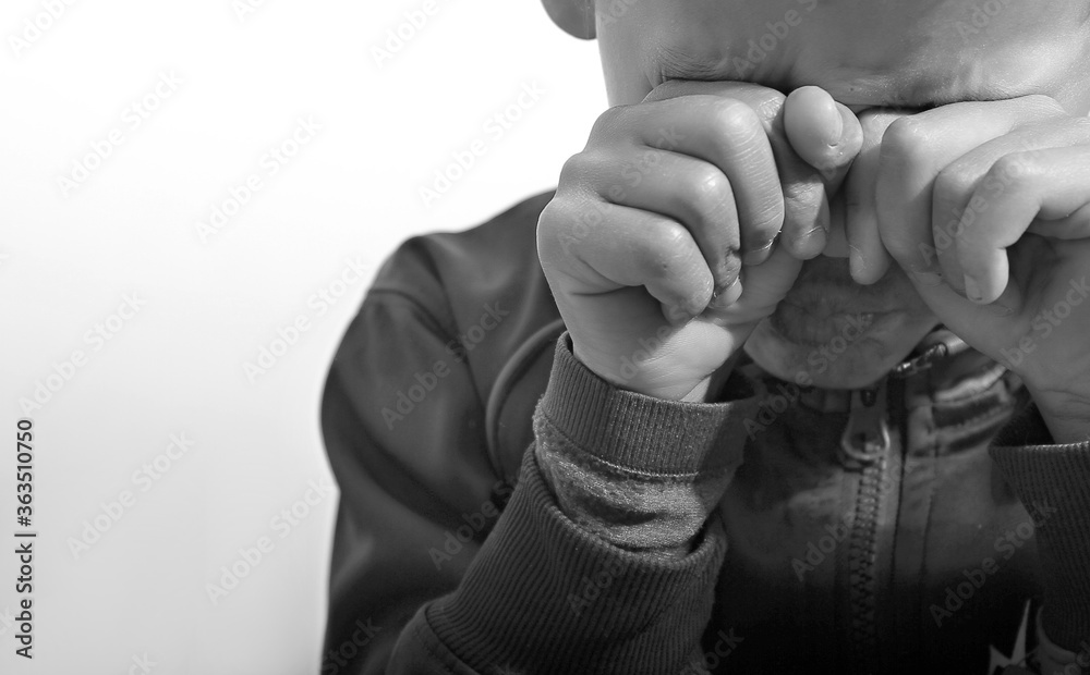 Fototapeta premium boy crying in poverty with no help crying alone and all by himself on white background stock photo