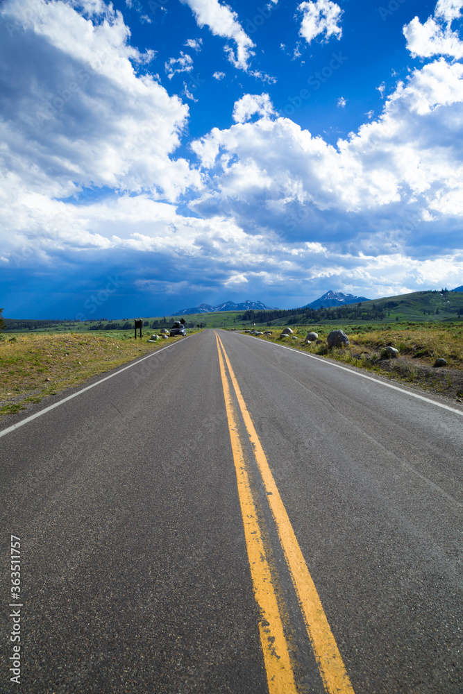 Straight road under cloudy sky in Yellowstone Straight road under cloudy sky in Yellowstone