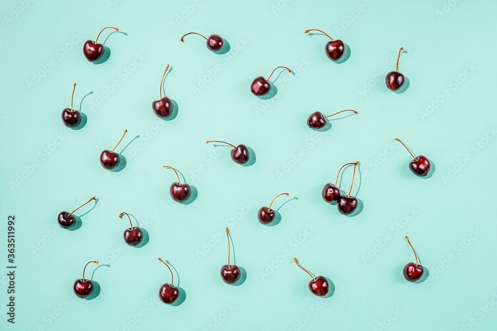 Bright pattern with ripe cherry on blue. Top view. Bright pattern with ripe cherry on blue. Top view.