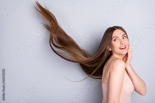 Close-up profile side view portrait of her she nice attractive lovely pretty dreamy cute cheerful well-groomed brown-haired girl wind blowing silky hair isolated on light gray pastel color background
