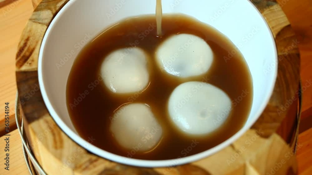 Pouring ginger ale in mochi bowl , in door Chiangmai Thailand Pouring ginger ale in mochi bowl , in door Chiangmai Thailand