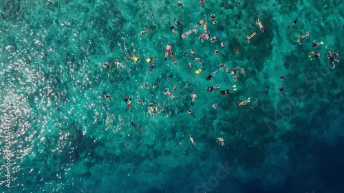 Sunny tourists holiday on the gili meno beach. Busy day on the beach with people enjoying in sun and gili meno statues. Aerial top view in august 2019 Gili Meno, Lombok, Indonesia photo