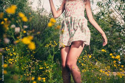 Happy girl. Closeup of the legs of the girl dancing outdoors in summertime