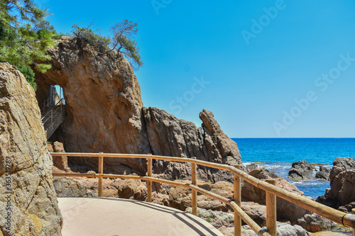 Path beside the Mediterranean sea, big rocks next to the coast in nature photo