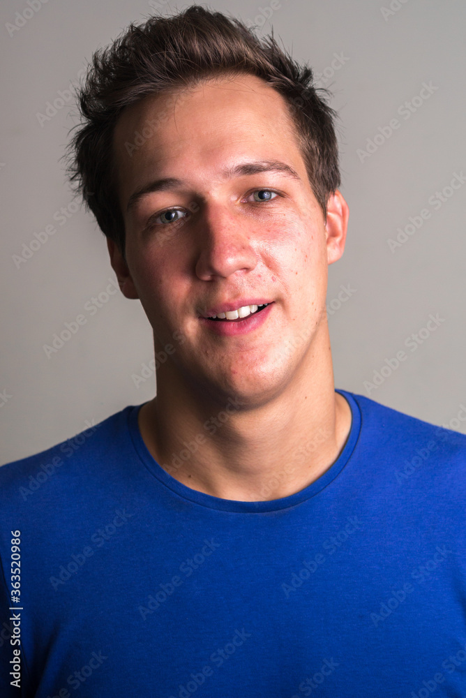 Fototapeta premium Face of happy young handsome man smiling