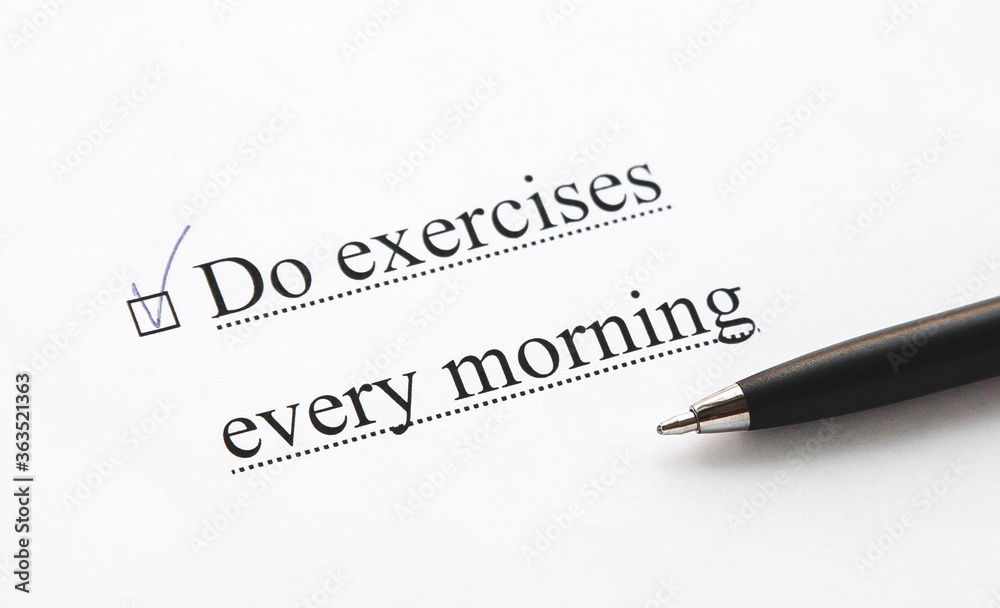 a piece of paper with the inscription do exercises every morning from to do list with a tick 